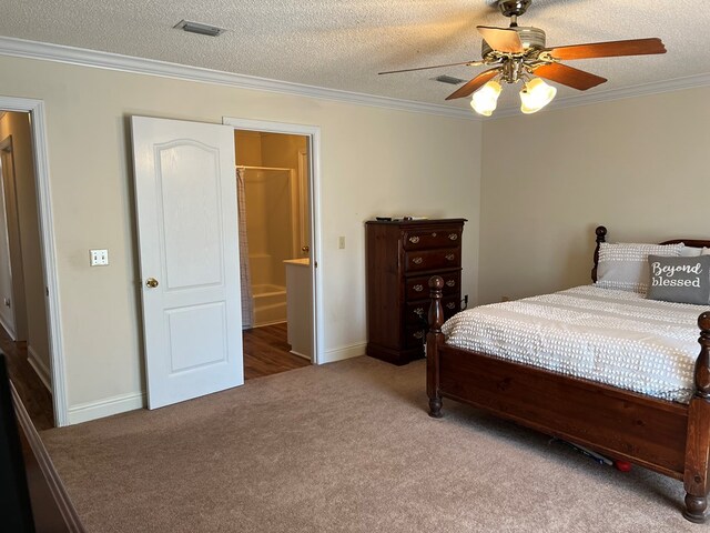 3374 Lake Oak Ridge Dr, Enterprise, AL 36330 - carpeted bedroom with crown molding, a textured ceiling, a ceiling fan, baseboards, and ensuite bathroom