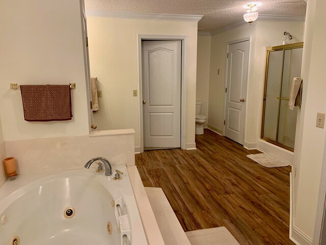 3374 Lake Oak Ridge Dr, Enterprise, AL 36330 - bathroom with a shower stall, a whirlpool tub, toilet, wood finished floors, and a textured ceiling
