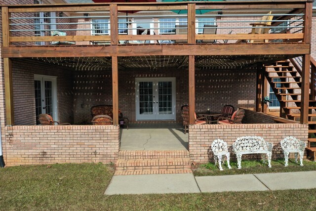 3374 Lake Oak Ridge Dr, Enterprise, AL 36330 - back of property featuring french doors, brick siding, a patio, a wooden deck, and stairs