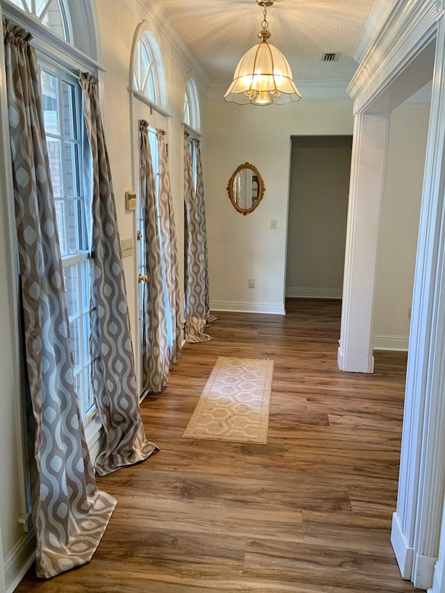 3374 Lake Oak Ridge Dr, Enterprise, AL 36330 - foyer featuring ornamental molding, wood finished floors, baseboards, and a chandelier
