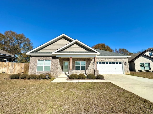 craftsman house featuring a front yard and a garage