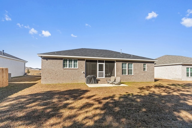 back of property featuring a sunroom, a yard, and a patio