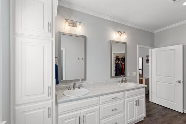 bathroom featuring hardwood / wood-style flooring, vanity, and crown molding