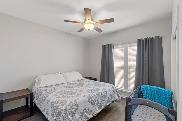 bedroom with ceiling fan and dark wood-type flooring