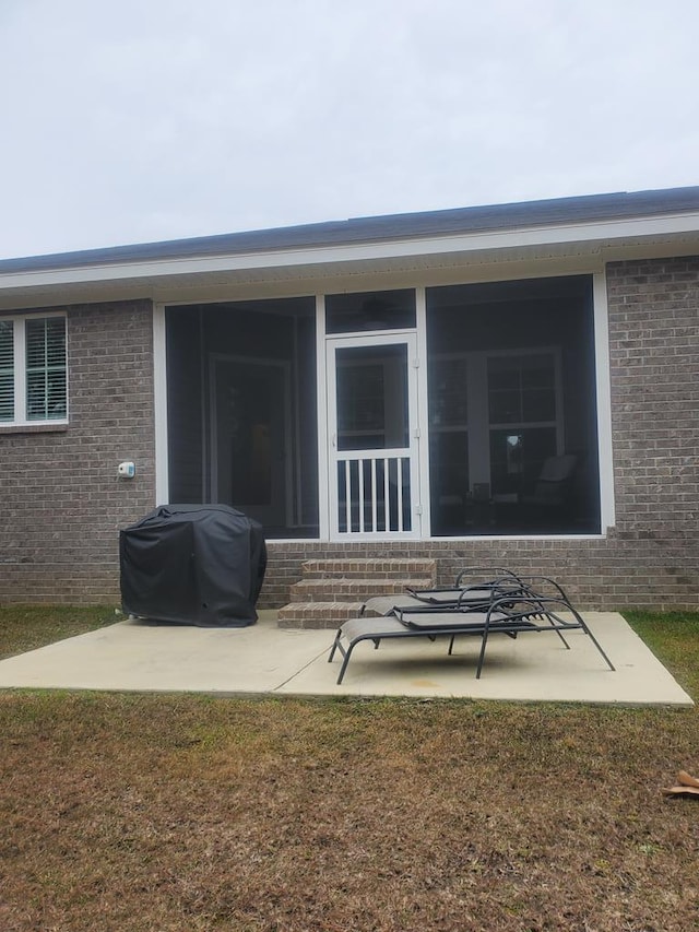 rear view of house with a patio area and a lawn