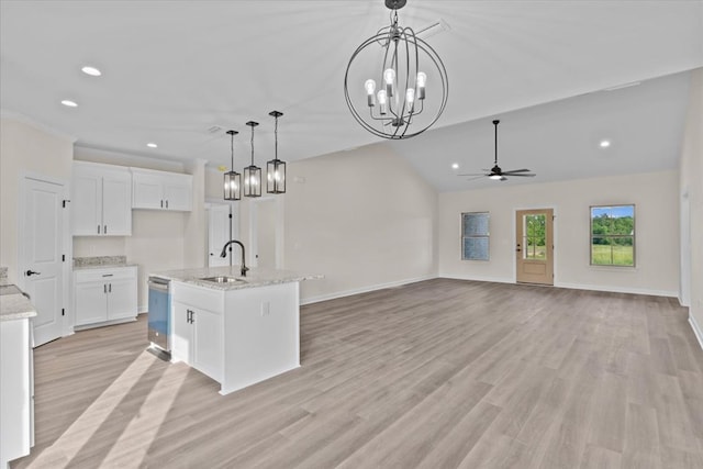 kitchen with white cabinets, stainless steel dishwasher, a sink, recessed lighting, and ceiling fan with notable chandelier