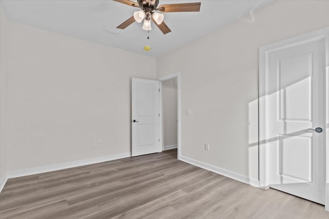 unfurnished bedroom with light wood-style flooring, baseboards, and a ceiling fan