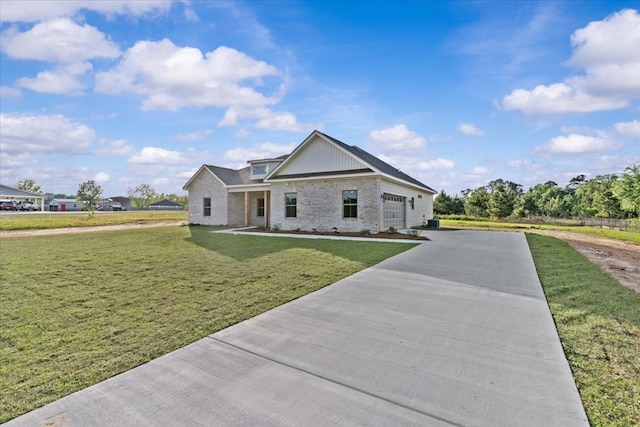 view of front of house with brick siding, driveway, and a front lawn