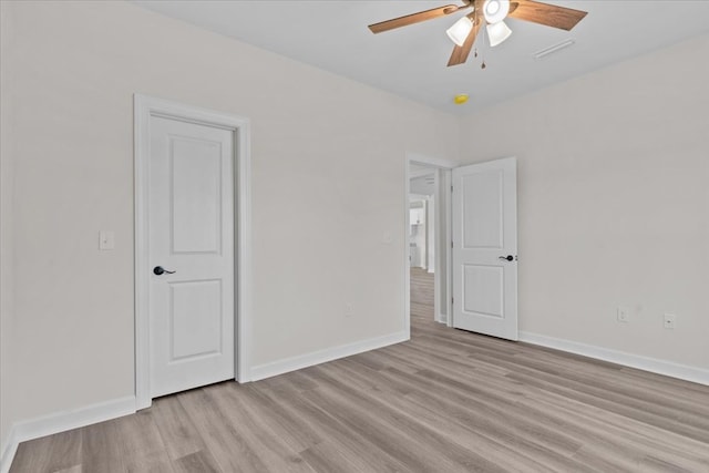 unfurnished bedroom with light wood-type flooring, baseboards, and ceiling fan