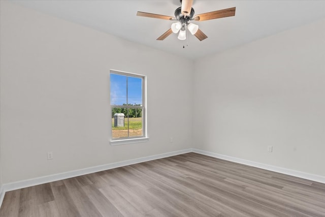 spare room featuring baseboards, a ceiling fan, and wood finished floors