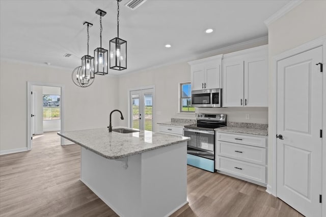 kitchen with a kitchen island with sink, french doors, a sink, crown molding, and appliances with stainless steel finishes