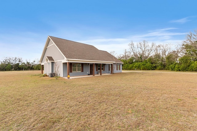 view of front of property featuring central AC, a front lawn, and a porch