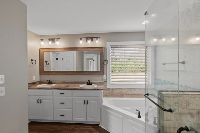 bathroom featuring vanity and shower with separate bathtub