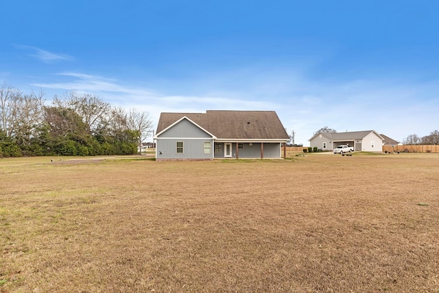 back of house featuring a yard