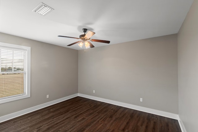 spare room with dark hardwood / wood-style flooring and ceiling fan