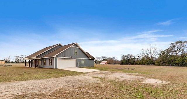 view of home's exterior with a garage and a lawn