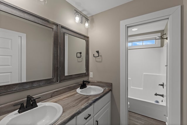 full bathroom featuring vanity, bathing tub / shower combination, and toilet