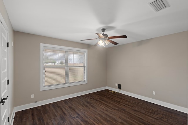 unfurnished room featuring dark wood-type flooring and ceiling fan