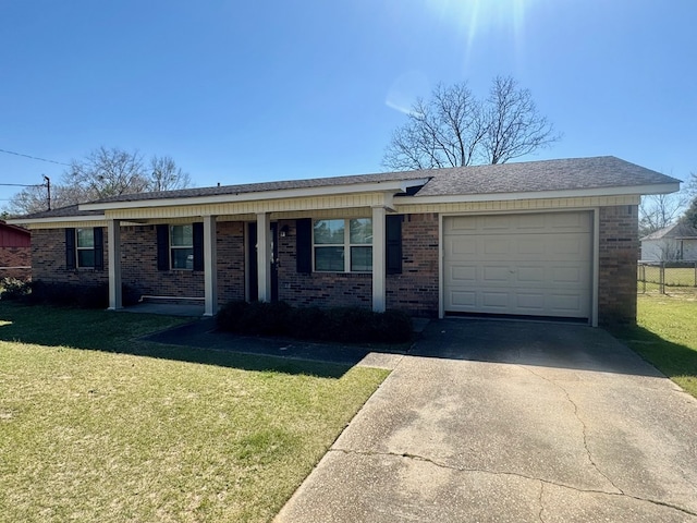 ranch-style house featuring a garage, driveway, brick siding, and a front yard