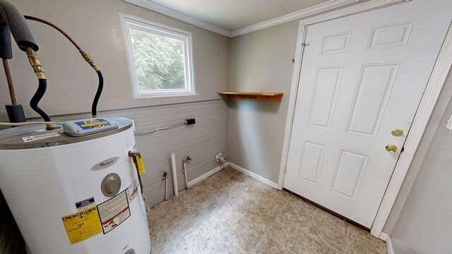 431 E Eufaula St, Ozark, AL 36360 - laundry area with electric water heater, wood walls, ornamental molding, and baseboards