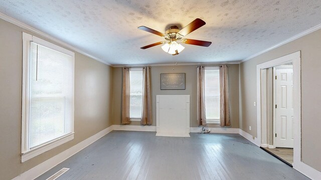 431 E Eufaula St, Ozark, AL 36360 - empty room with baseboards, ceiling fan, wood finished floors, a textured ceiling, and ornamental molding