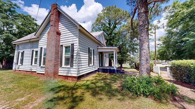 431 E Eufaula St, Ozark, AL 36360 - view of home's exterior featuring a chimney, crawl space, and metal roof