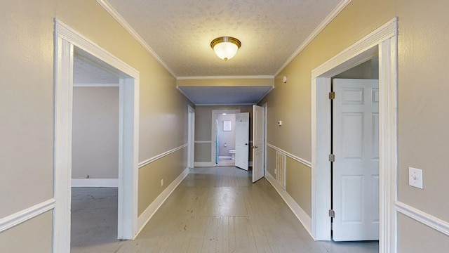 431 E Eufaula St, Ozark, AL 36360 - hall with a textured ceiling, wood finished floors, crown molding, and baseboards