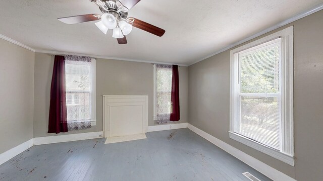 431 E Eufaula St, Ozark, AL 36360 - spare room with baseboards, wood finished floors, crown molding, healthy amount of natural light, and a ceiling fan