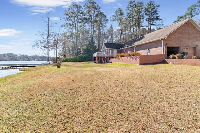 view of yard featuring a deck with water view