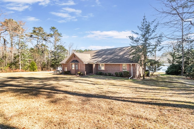 view of front facade with a front lawn and brick siding