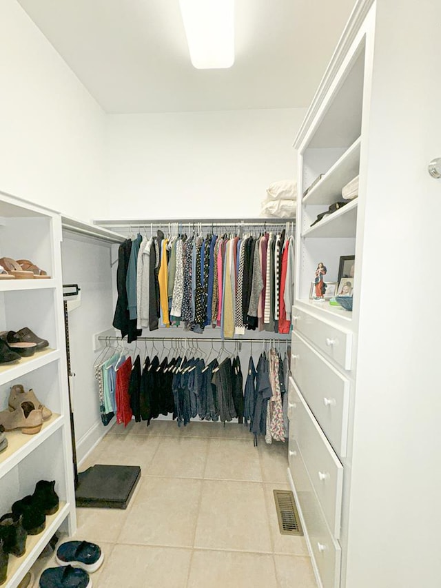 spacious closet with tile patterned floors