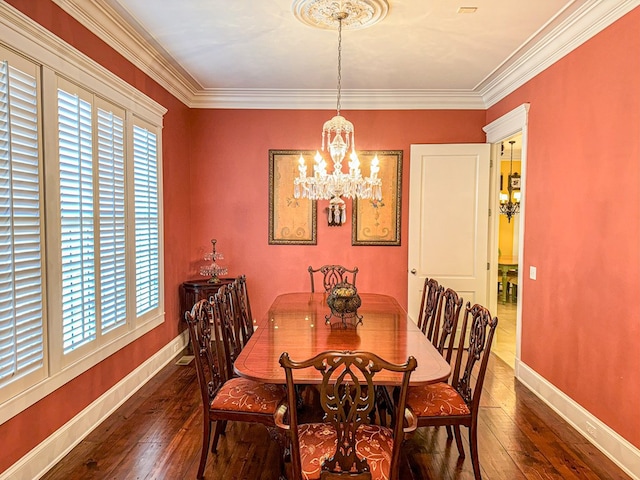 dining room with dark wood-type flooring, an inviting chandelier, and ornamental molding