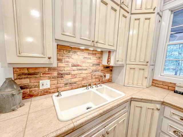 kitchen featuring sink and cream cabinetry