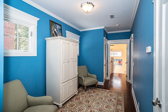 sitting room featuring hardwood / wood-style floors and ornamental molding