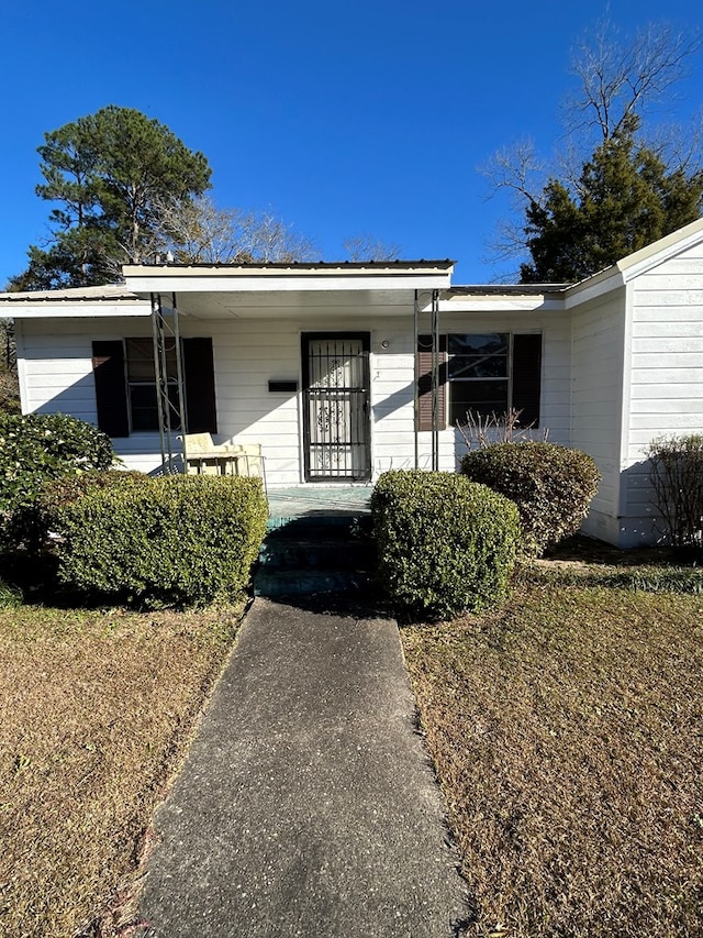 view of exterior entry with a porch