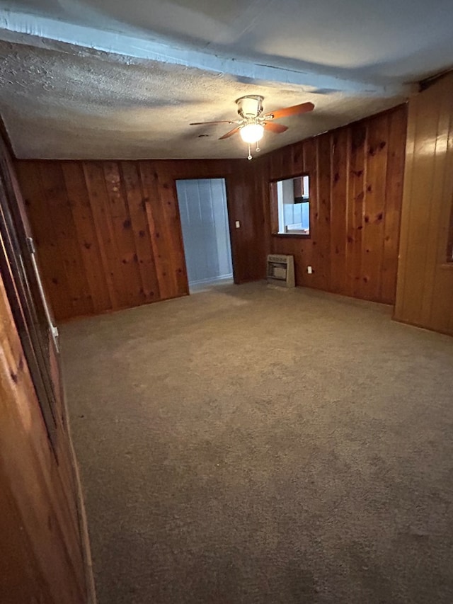 carpeted empty room with wooden walls