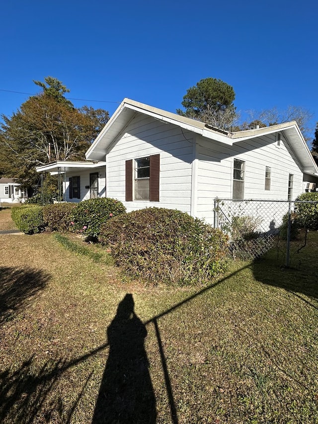 view of property exterior with a lawn