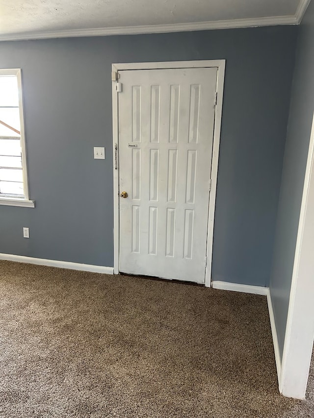 unfurnished bedroom featuring carpet flooring and crown molding