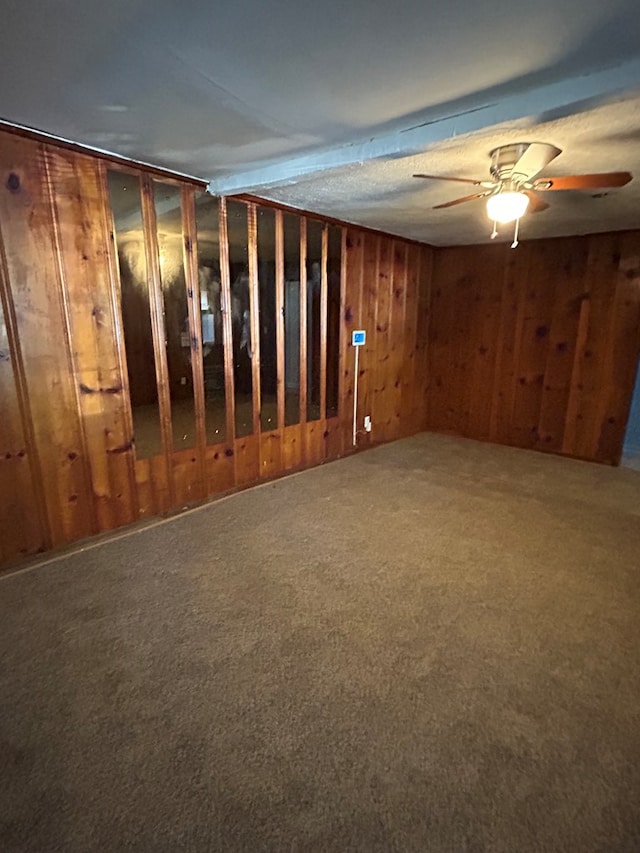 basement with carpet floors and ceiling fan