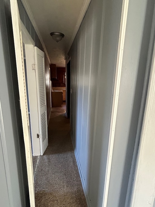 corridor with carpet flooring and ornamental molding