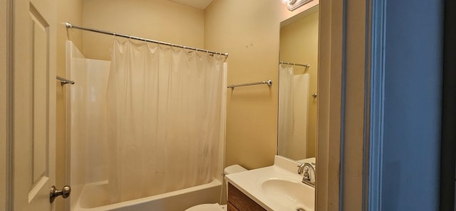 full bathroom with vanity, shower / tub combo, and toilet