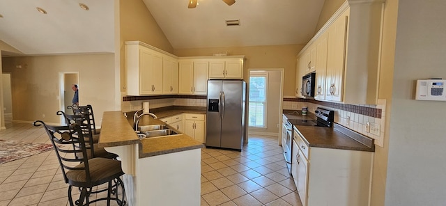 kitchen featuring a breakfast bar, white cabinetry, sink, kitchen peninsula, and stainless steel appliances