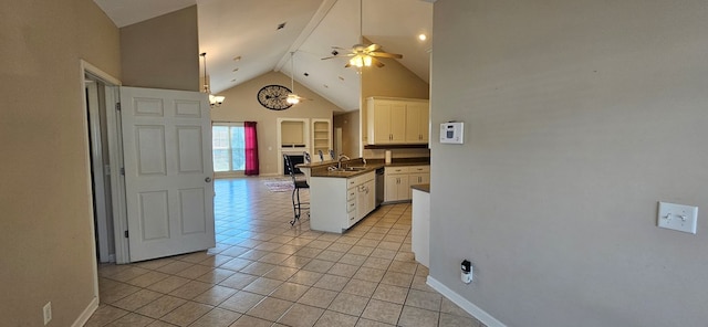 kitchen with light tile patterned flooring, a breakfast bar, white cabinetry, high vaulted ceiling, and ceiling fan