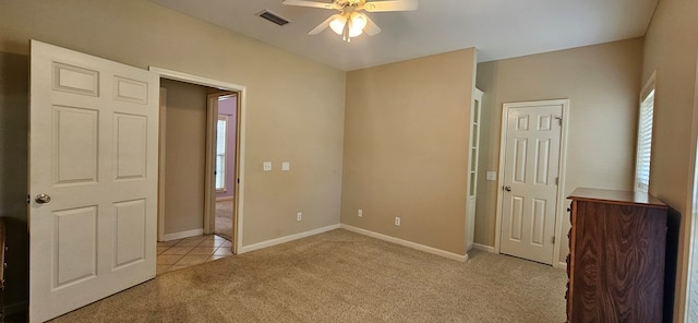 unfurnished bedroom with light colored carpet and ceiling fan