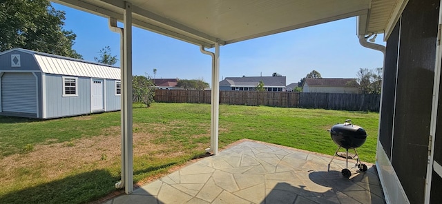 view of yard with a storage shed and a patio area