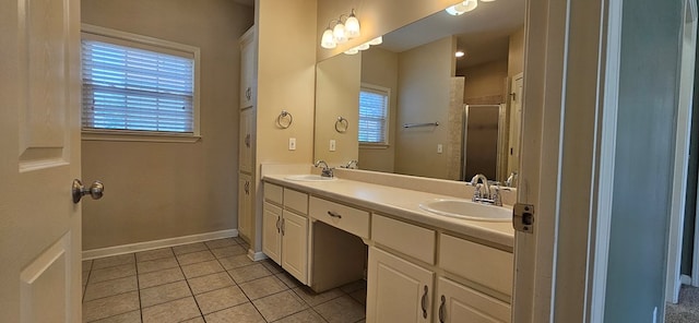 bathroom with vanity, plenty of natural light, tile patterned floors, and walk in shower