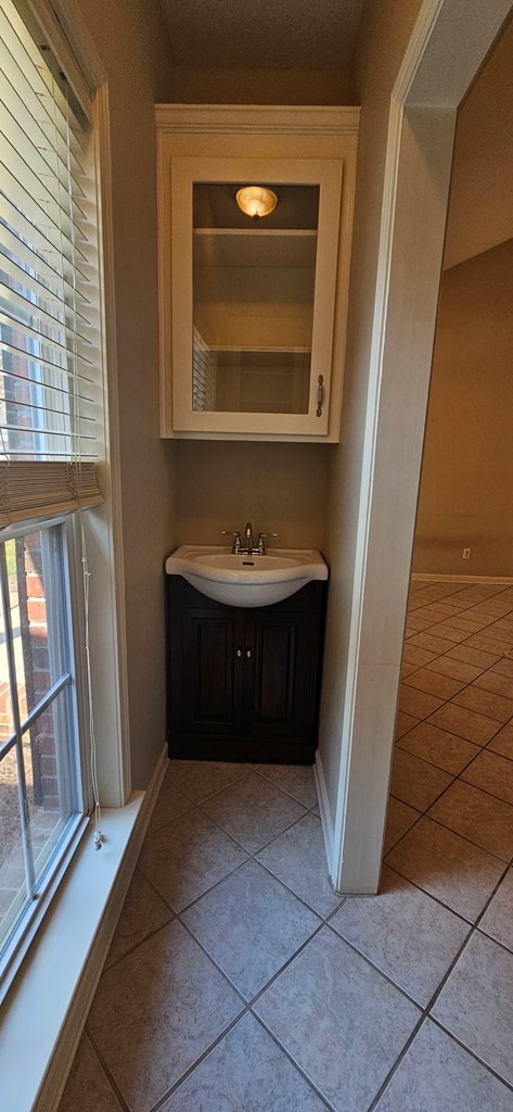 bathroom featuring tile patterned flooring and vanity