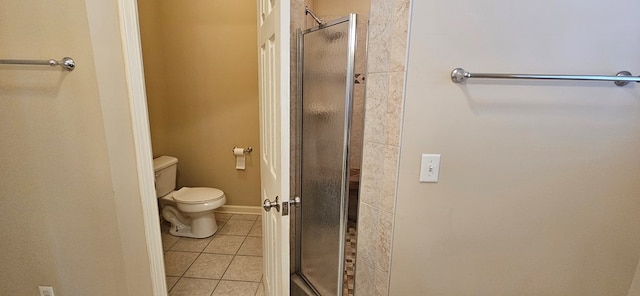 bathroom with toilet, an enclosed shower, and tile patterned flooring