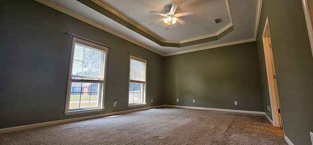 carpeted empty room featuring ornamental molding, a raised ceiling, and ceiling fan