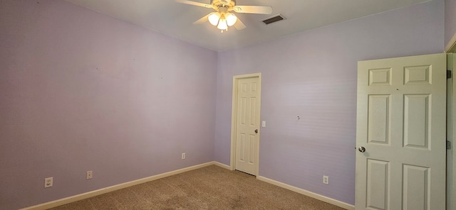 unfurnished room with ceiling fan and carpet